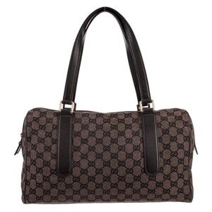 Gucci GG canvas Charmy Boston bag featuring a monogram design with dark leather